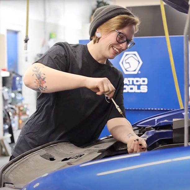 Service tech working under hood of vehicle